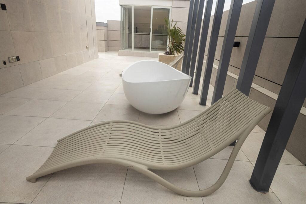 Brum Height 6: Terrace seating and freestanding tub beneath a pergola